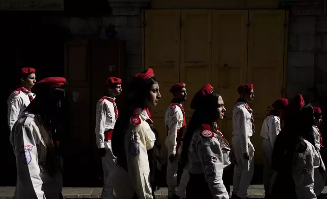 Scouts line up during the traditional Christian procession towards the Church of the Nativity, traditionally believed to be the birthplace of Jesus, on Christmas Eve, in the West Bank city of Bethlehem, Tuesday, Dec. 24, 2024. (AP Photo/Matias Delacroix)