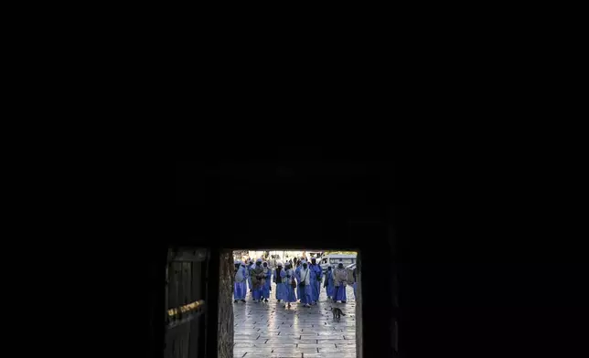 Nigerian worshippers walk along the Church of the Nativity, traditionally believed to be the birthplace of Jesus, on Christmas Eve, in the West Bank city of Bethlehem, Tuesday, Dec. 24, 2024. (AP Photo/Matias Delacroix)