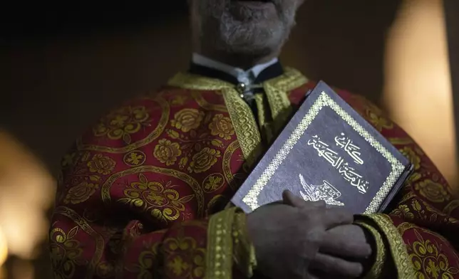 Priest Abuna Mata attends the Christmas mass in the Greek Orthodox convent Saint Takla, in Maaloula, some 60 km northern Damascus, Syria, Tuesday, Dec. 24, 2024. (AP Photo/Leo Correa)