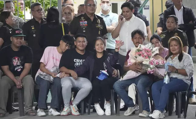 Mary Jane Veloso, front center, a Filipino woman who spent almost 15 years in an Indonesian prison for drug trafficking and was nearly executed by firing squad in 2015, waves as is reunited with family at the Correctional Institution for Women in Mandaluyong, Philippines Wednesday, Dec. 18, 2024. (AP Photo/Aaron Favila)