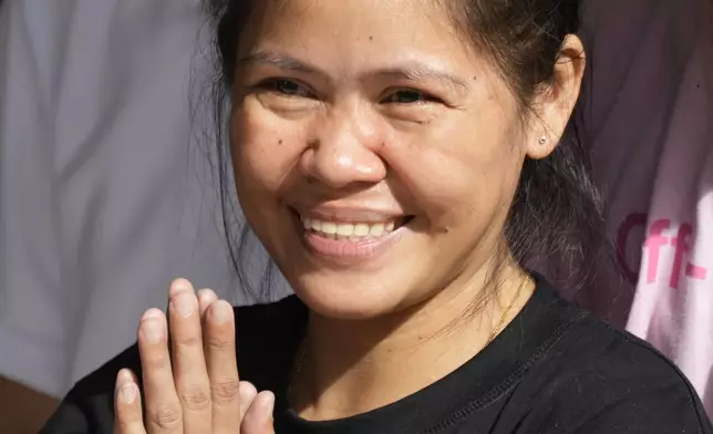 Mary Jane Veloso, a Filipino woman who spent almost 15 years in an Indonesian prison for drug trafficking and was nearly executed by firing squad in 2015, smiles as she arrives at the Correctional Institution for Women in Mandaluyong, Philippines on Wednesday, Dec. 18, 2024. (AP Photo/Aaron Favila)