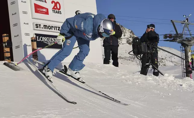 United States' Lindsey Vonn starts a course inspection before competing in an alpine ski, women's World Cup super G, in St. Moritz, Switzerland, Saturday, Dec. 21, 2024. (AP Photo/Marco Trovati