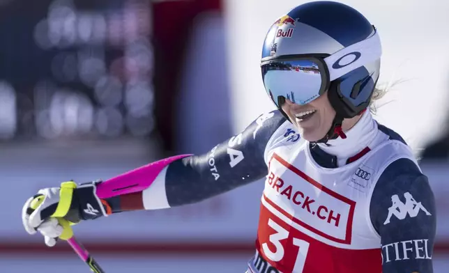 United States' Lindsey Vonn, right, smiles after completing an alpine ski, women's World Cup super G, in St. Moritz, Switzerland, Saturday, Dec. 21, 2024. (Til Buergy/Keystone via AP)