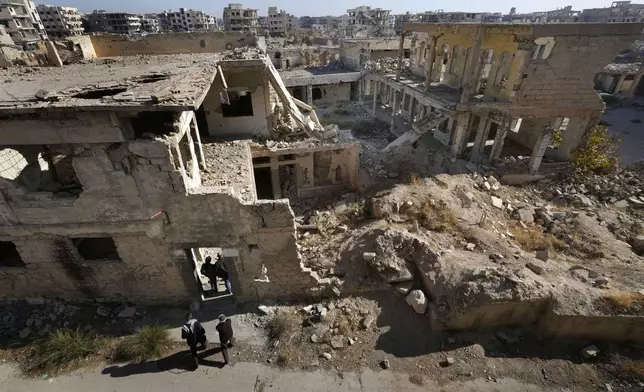 Syrian citizens check the destroyed Jobar Synagogue, also known as Eliyahu Hanavi, in Jobar neighborhood, in Damascus, Syria, Wednesday, Dec. 25, 2024. (AP Photo/Hussein Malla)