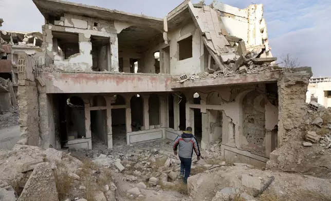 A Syrian man observes the destroyed Jobar Synagogue, also known as Eliyahu Hanavi, in Jobar neighborhood, in Damascus, Syria, Saturday, Dec. 21, 2024. (AP Photo/Hussein Malla)