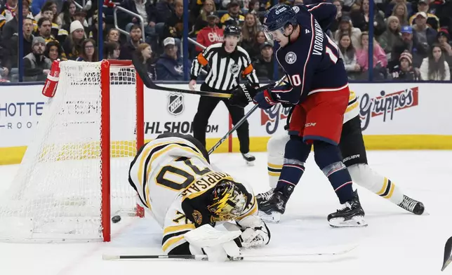 Columbus Blue Jackets' Dmitri Voronkov, right, scores against Boston Bruins' Joonas Korpisalo during the second period of an NHL hockey game Friday, Dec. 27, 2024, in Columbus, Ohio. (AP Photo/Jay LaPrete)