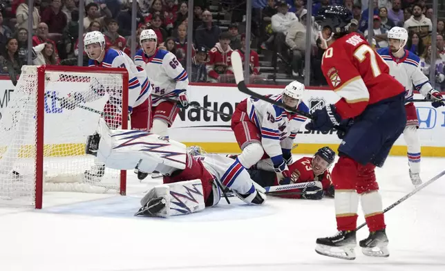 Florida Panthers center Jesper Boqvist (70) watches after scoring a goal against New York Rangers goaltender Igor Shesterkin, bottom left, during the second period of an NHL hockey game Monday, Dec. 30, 2024, in Sunrise, Fla. (AP Photo/Lynne Sladky)