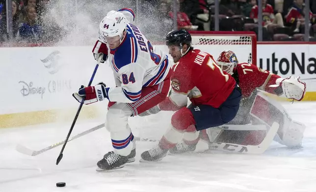 New York Rangers center Adam Edstrom (84) goes for the puck against Florida Panthers defenseman Dmitry Kulikov (7) during the first period of an NHL hockey game, Monday, Dec. 30, 2024, in Sunrise, Fla. (AP Photo/Lynne Sladky)