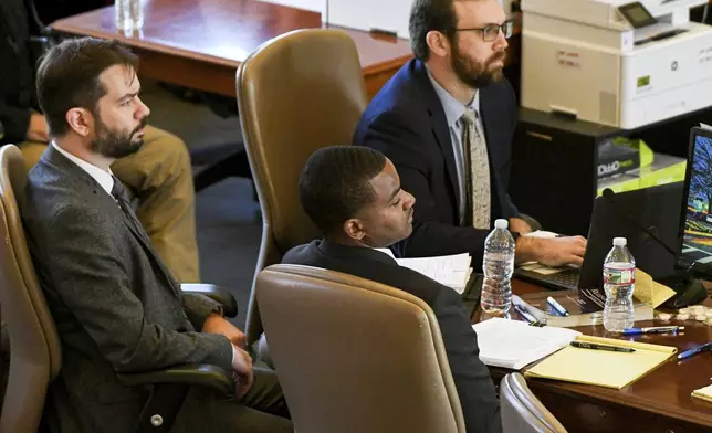 Sheldon Timothy Herrington Jr., foreground, who is on trial for the murder of University of Mississippi student Jimmie "Jay" Lee, looks over at his attorney in Oxford, Miss. on Tuesday, Dec. 3, 2024. (Bruce Newman/The Northeast Daily Journal via AP, Pool)