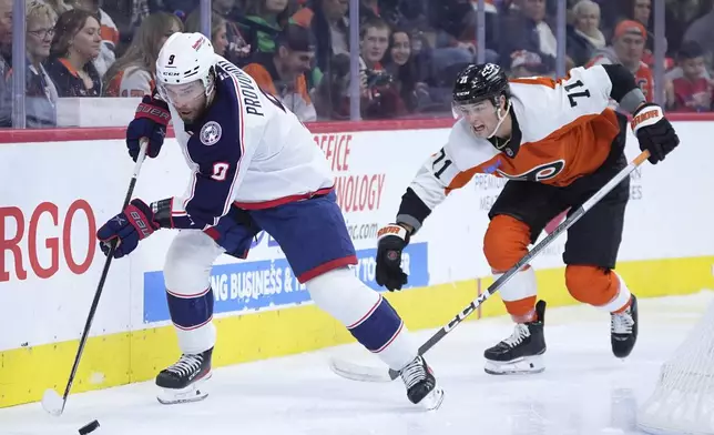 Columbus Blue Jackets' Ivan Provorov, left, tries to keep the puck away from Philadelphia Flyers' Tyson Foerster during the second period of an NHL hockey game, Saturday, Dec. 21, 2024, in Philadelphia. (AP Photo/Matt Slocum)