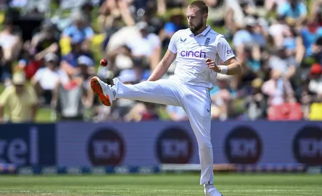 England's Gus Atkinson kicks at the ball during play on day two of the third cricket test between England and New Zealand in Hamilton, New Zealand, Sunday, Dec. 15, 2024. (Andrew Cornaga/Photosport via AP)