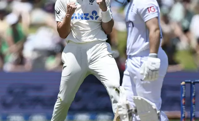 New Zealand bowler Matt Henry celebrates the wicket of England's Ben Duckett, right, during play on day two of the third cricket test between England and New Zealand in Hamilton, New Zealand, Sunday, Dec. 15, 2024. (Andrew Cornaga/Photosport via AP)