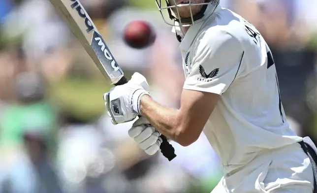 New Zealand's Mitchell Santner bats during play on day two of the third cricket test between England and New Zealand in Hamilton, New Zealand, Sunday, Dec. 15, 2024. (Andrew Cornaga/Photosport via AP)