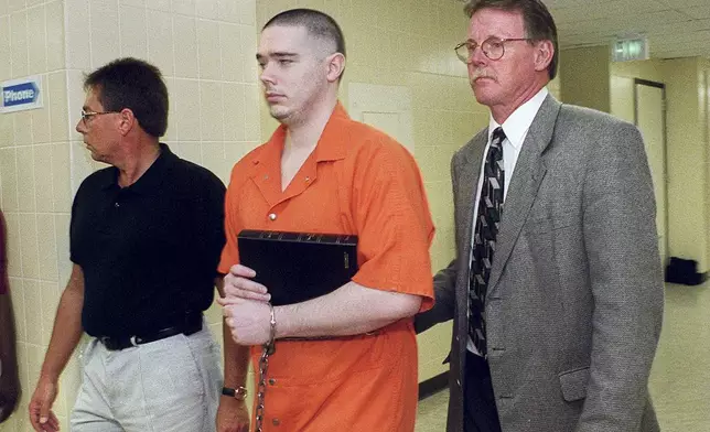 Joseph Corcoran is led to the City-County Lockup on Aug. 26, 1999, in Fort Wayne, Ind., after being sentenced to death in the slayings of four people in July 1997. (Matt Sullivan/The Journal-Gazette via AP)