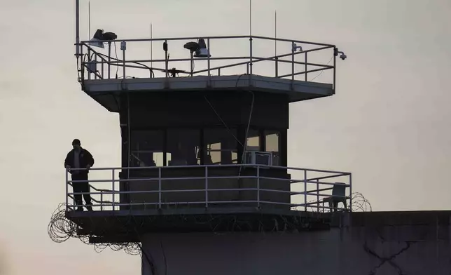 A guard stands in a tower at Indiana State Prison where, barring last-minute court action or intervention by Gov. Eric Holcomb, Joseph Corcoran, 49, convicted in the 1997 killings of his brother and three other people, is scheduled to be put to death by lethal injection before sunrise Tuesday, Dec. 17, 2024, in Michigan City, Ind. (AP Photo/Erin Hooley)