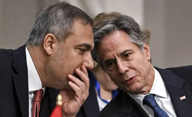 Turkey's Foreign Minister Hakan Fidan, left, speaks with US Secretary of State Antony Blinken during a meeting with the foreign ministers of the Arab Contact Group on Syria in Jordan's southern Red Sea coastal city of Aqaba, Saturday Dec. 14, 2024. (Andrew Caballero-Reynolds/Pool via AP)