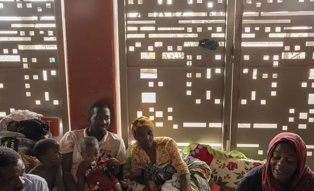 Mohamed Ankidine, 28, third left, with feet injuries, Saindou Dahabou who suffers from diabetes, and Alibouna Haithouna, 33, find refuge at the Lycée des Lumières after losing their homes, in Mamoudzou, Mayotte, Thursday, Dec. 19, 2024. (AP Photo/Adrienne Surprenant)