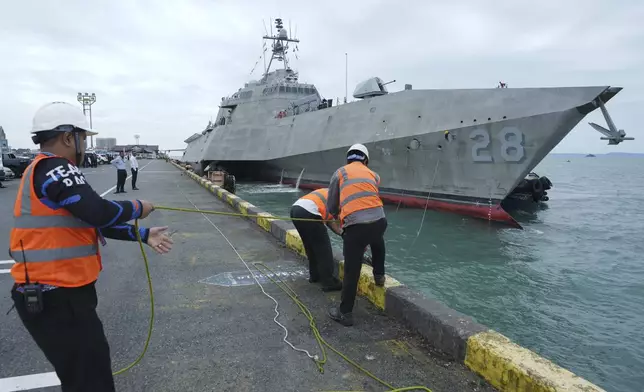 Cambodian port members tie USS Savannah as it arrives for a port call at Sihanoukville port, Cambodia, Monday, Dec. 16, 2024. (AP Photo/Heng Sinith)