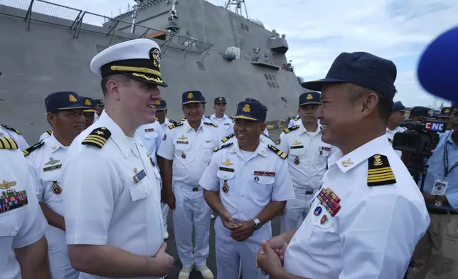 Daniel A. Sledz, left, commanding officer of USS Savannah, talks with a Cambodian naval staff member as it arrives for a port call at Sihanoukville port, Cambodia, Monday, Dec. 16, 2024. (AP Photo/Heng Sinith)