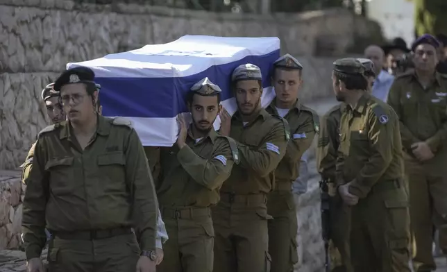 Israeli soldiers carry the coffin of combat engineer squad commander Staff Sgt. Zamir Burke, 20, from Beit Shemesh, during his funeral at Mount Herzl military cemetery in Jerusalem, Israel, Sunday Nov. 1, 2024. Burke was killed in combat with Hamas at the Jabaliya refugee camp in Gaza. (APcPhoto/Mahmoud Illean)