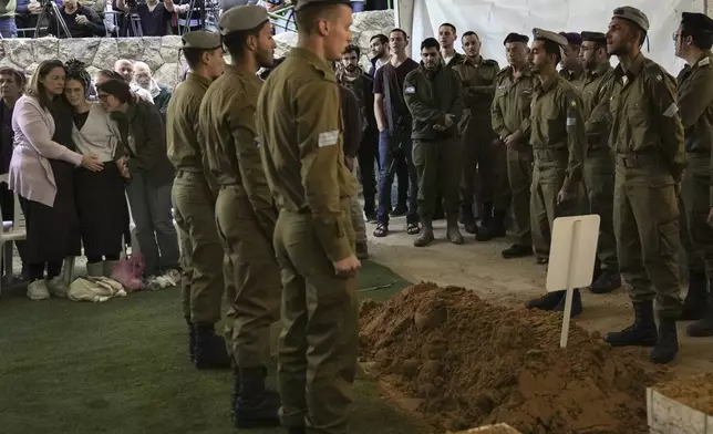 Close relatives, left, of combat engineer squad commander Staff Sgt. Zamir Burke, 20, from Beit Shemesh, mourn during his funeral at Mount Herzl military cemetery in Jerusalem, Israel, Sunday Nov. 1, 2024. Burke was killed in combat with Hamas at the Jabaliya refugee camp in Gaza. (APcPhoto/Mahmoud Illean)