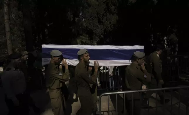 Israeli soldiers carry the coffin of combat engineer squad commander Staff Sgt. Zamir Burke, 20, from Beit Shemesh, during his funeral at Mount Herzl military cemetery in Jerusalem, Israel, Sunday Nov. 1, 2024. Burke was killed in combat with Hamas at the Jabaliya refugee camp in Gaza. (APcPhoto/Mahmoud Illean)