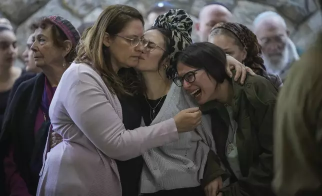 Close relatives of combat engineer squad commander Staff Sgt. Zamir Burke, 20, from Beit Shemesh, mourn during his funeral at Mount Herzl military cemetery in Jerusalem, Israel, Sunday Nov. 1, 2024. Burke was killed in combat with Hamas at the Jabaliya refugee camp in Gaza. (APcPhoto/Mahmoud Illean)