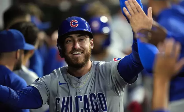 FILE - Chicago Cubs' Cody Bellinger celebrates after scoring on a home run by Isaac Paredes during the third inning of a baseball game against the Chicago White Sox, Friday, Aug. 9, 2024, in Chicago. (AP Photo/Erin Hooley, File)