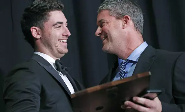 FILE - National League Rookie of the Year Cody Bellinger, left, of the Los Angeles Dodgers, receives his award from his father Clay Bellinger during the New York Chapter of the Baseball Writers' Association of America annual dinner in New York, Sunday, Jan. 28, 2018. (AP Photo/Kathy Willens, File)