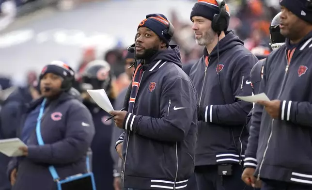 Chicago Bears interim head coach Thomas Brown, center looks at the scoreboard during the first half of an NFL football game against the Detroit Lions on Sunday, Dec. 22, 2024, in Chicago. (AP Photo/Nam Y. Huh)