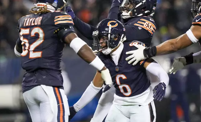 Chicago Bears cornerback Kyler Gordon (6) celebrates his fumble recovery with teammates during the second half of an NFL football game against the Seattle Seahawks, Thursday, Dec. 26, 2024, in Chicago. (AP Photo/Nam Y. Huh)