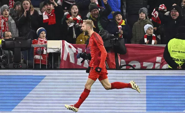 Munich's Konrad Laimer celebrates scoring during the Bundesliga soccer match between Bayern Munich and RB Leipzig at the Allianz Arena, Munich, Germany, Friday Dec. 20, 2024. (Tom Weller/dpa via AP)