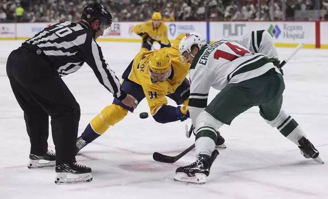 Nashville Predators center Steven Stamkos (91) takes a face off against Minnesota Wild center Joel Eriksson Ek (14) during the second period of an NHL hockey game Saturday, Nov. 30, 2024, in St. Paul, Minn. (AP Photo/Bailey Hillesheim)