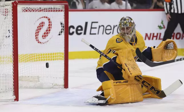 Nashville Predators goaltender Juuse Saros (74) watches a shot by Minnesota Wild defenseman Declan Chisholm go into the net during the first period of an NHL hockey game Saturday, Nov. 30, 2024, in St. Paul, Minn. (AP Photo/Bailey Hillesheim)