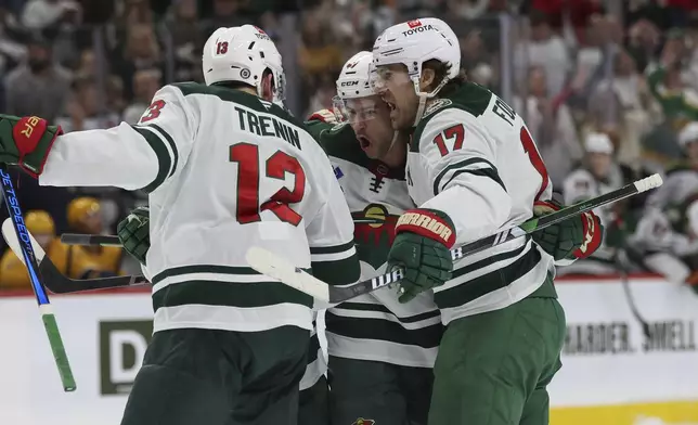 Minnesota Wild defenseman Declan Chisholm (47) celebrates with teammates after scoring during the first period of an NHL hockey game against the Nashville Predators, Saturday, Nov. 30, 2024, in St. Paul, Minn. (AP Photo/Bailey Hillesheim)