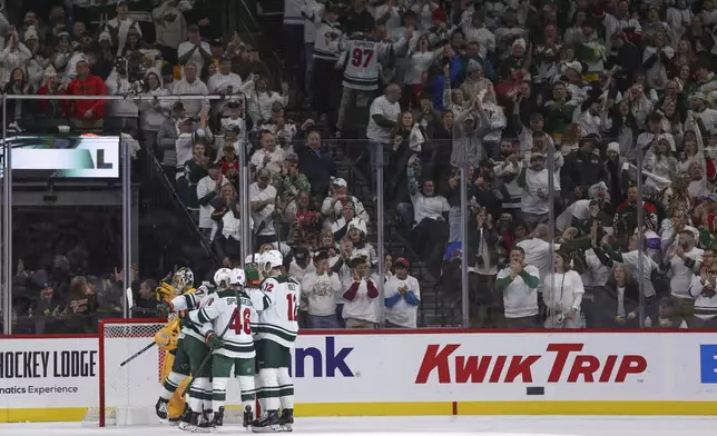 Minnesota Wild left wing Kirill Kaprizov celebrates with teammates after scoring a goal during the second period of an NHL hockey game against the Nashville Predators, Saturday, Nov. 30, 2024, in St. Paul, Minn. (AP Photo/Bailey Hillesheim)