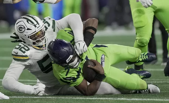 Green Bay Packers' Rashan Gary sacks Seattle Seahawks' Geno Smith during the first half of an NFL football game Sunday, Dec. 15, 2024, in Seattle. (AP Photo/Stephen Brashear)