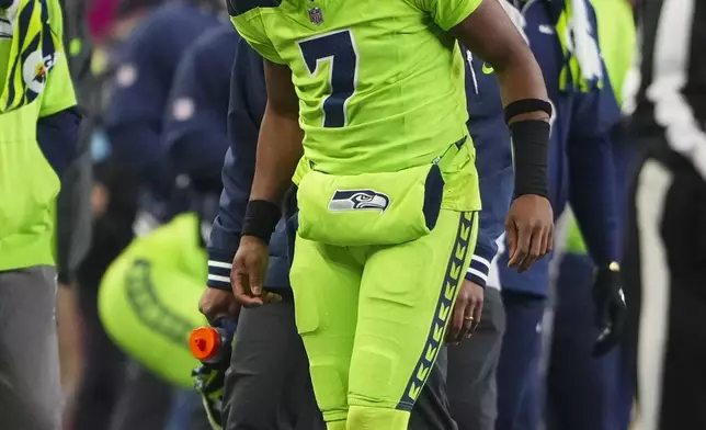 Seattle Seahawks' Geno Smith is hurt during the second half of an NFL football game against the Green Bay Packers Sunday, Dec. 15, 2024, in Seattle. (AP Photo/Lindsey Wasson)