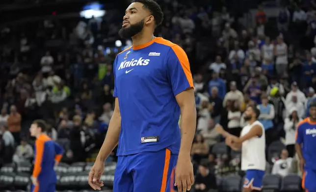 New York Knicks center Karl-Anthony Towns stands on the court before an NBA basketball game against the Minnesota Timberwolves, Thursday, Dec. 19, 2024, in Minneapolis. (AP Photo/Abbie Parr)