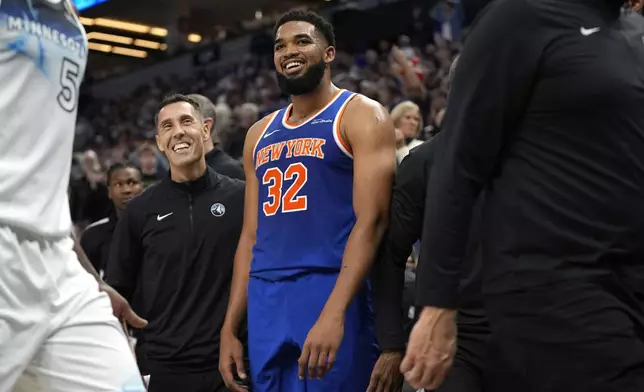 New York Knicks center Karl-Anthony Towns (32) reacts after a 3-point shot made by Minnesota Timberwolves guard Anthony Edwards at the buzzer to end the first half of an NBA basketball game, Thursday, Dec. 19, 2024, in Minneapolis. (AP Photo/Abbie Parr)