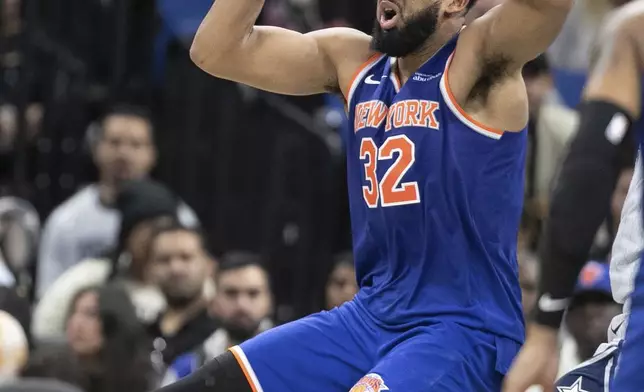 New York Knicks center Karl-Anthony Towns (32)looks to pass the ball during the second half of an NBA basketball game against the Orlando Magic, Sunday, Dec. 15, 2024, in Orlando, Fla. (AP Photo/Alan Youngblood)