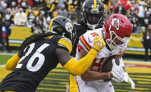 Kansas City Chiefs wide receiver Justin Watson (84) scores a touchdown against Pittsburgh Steelers cornerback Donte Jackson (26) during the first half of an NFL football game, Wednesday, Dec. 25, 2024, in Pittsburgh. (AP Photo/Gene J. Puskar)