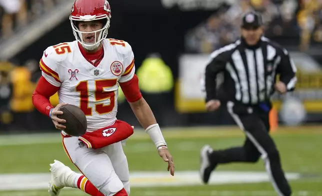 Kansas City Chiefs quarterback Patrick Mahomes (15) runs out of the backfield against the Pittsburgh Steelers during the first half of an NFL football game, Wednesday, Dec. 25, 2024, in Pittsburgh. (AP Photo/Matt Freed)