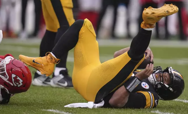 Pittsburgh Steelers quarterback Russell Wilson (3) is sacked by Kansas City Chiefs defensive end Mike Danna (51) during the second half of an NFL football game, Wednesday, Dec. 25, 2024, in Pittsburgh. (AP Photo/Gene J. Puskar)