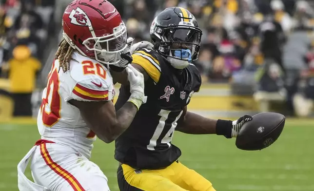 Kansas City Chiefs safety Justin Reid (20) hits Pittsburgh Steelers wide receiver George Pickens (14) during the second half of an NFL football game, Wednesday, Dec. 25, 2024, in Pittsburgh. (AP Photo/Gene J. Puskar)