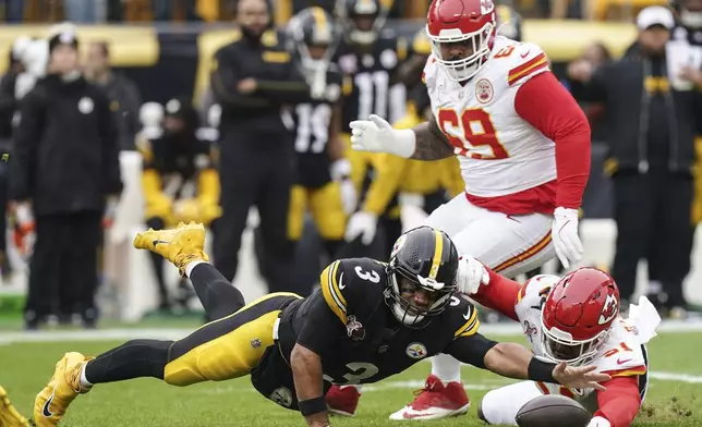 Pittsburgh Steelers quarterback Russell Wilson (3) reaches to recover his own fumble against Kansas City Chiefs defensive end Mike Danna (51) during the first half of an NFL football game, Wednesday, Dec. 25, 2024, in Pittsburgh. (AP Photo/Matt Freed)