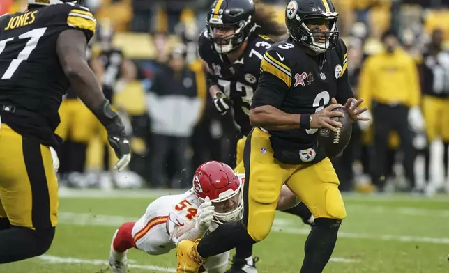 Pittsburgh Steelers quarterback Russell Wilson (3) runs from Kansas City Chiefs linebacker Leo Chenal (54) during the second half of an NFL football game, Wednesday, Dec. 25, 2024, in Pittsburgh. (AP Photo/Matt Freed)