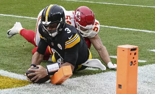 Pittsburgh Steelers quarterback Russell Wilson (3) runs into the end zone for a touchdown against Kansas City Chiefs linebacker Leo Chenal (54) during the first half of an NFL football game, Wednesday, Dec. 25, 2024, in Pittsburgh. (AP Photo/Matt Freed)