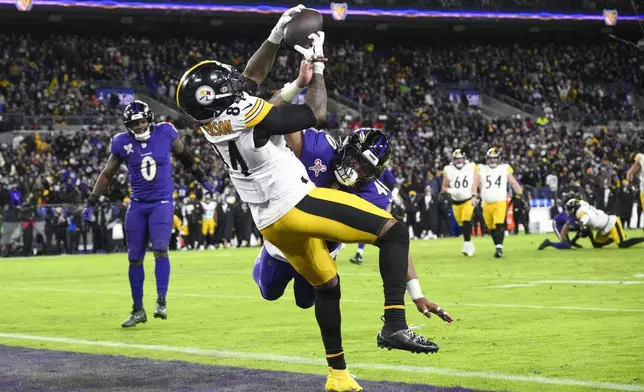 Pittsburgh Steelers running back Cordarrelle Patterson (84) catches a touchdown pass as Baltimore Ravens linebacker Malik Harrison defends during the second half of an NFL football game, Saturday, Dec. 21, 2024, in Baltimore. (AP Photo/Nick Wass)