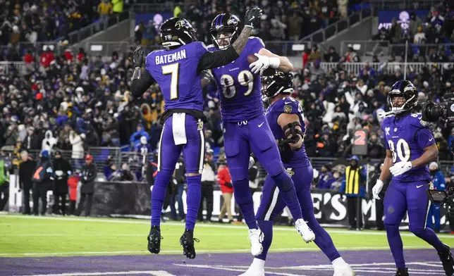 Baltimore Ravens tight end Mark Andrews (89) celebrates with wide receiver Rashod Bateman (7) after scoring a touchdown during the second half of an NFL football game against the Pittsburgh Steelers, Saturday, Dec. 21, 2024, in Baltimore. (AP Photo/Nick Wass)